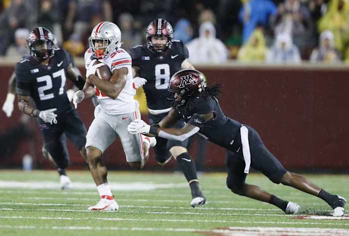 TreVeyon Henderson (32) gets past Minnesota Golden Gophers defensive back Michael Dixon (11) and scores a touchdown after a catch during the fourth quarter.